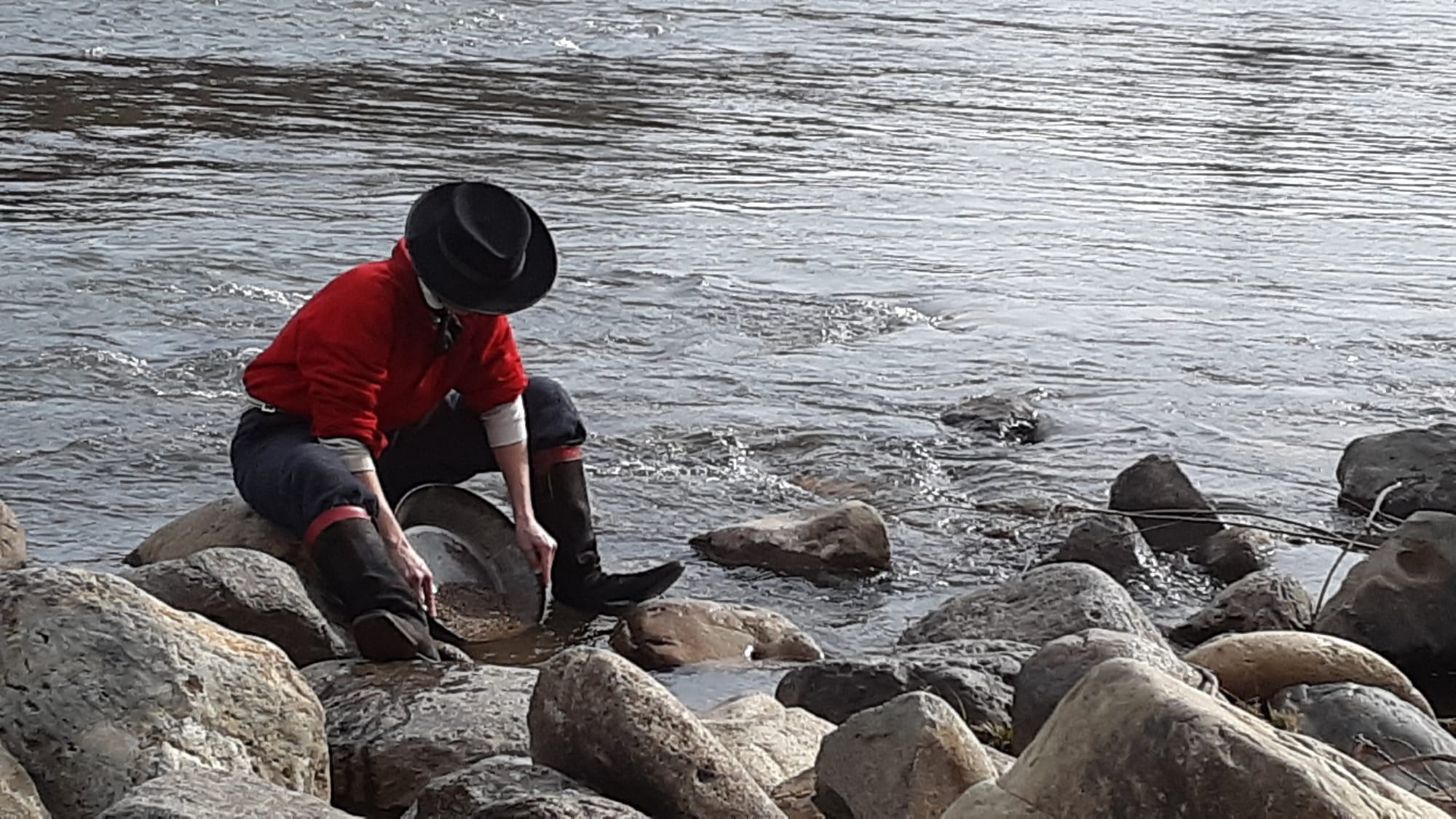 Photo of man panning for gold