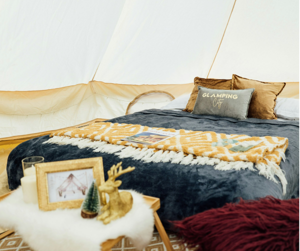 stock image of glamping tent with bed