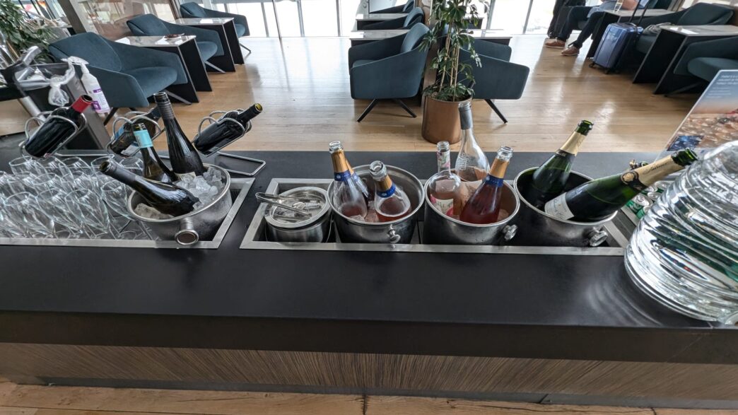 a group of bottles in buckets on a bar