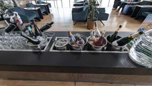 a group of bottles in buckets on a bar