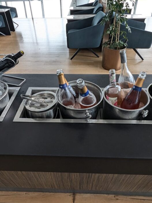 a group of bottles in buckets on a bar