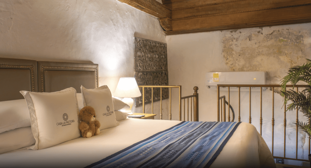 a bed with a teddy bear on it