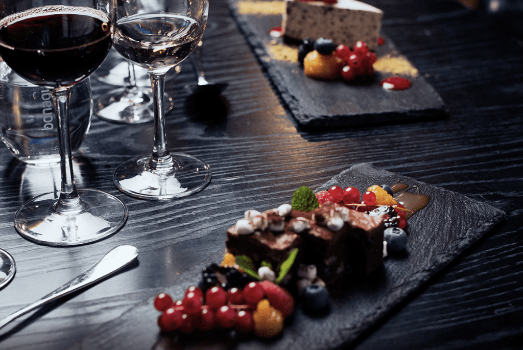 a plate of desserts and wine glasses