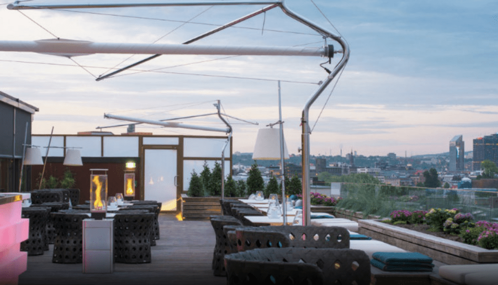 a rooftop patio with tables and chairs