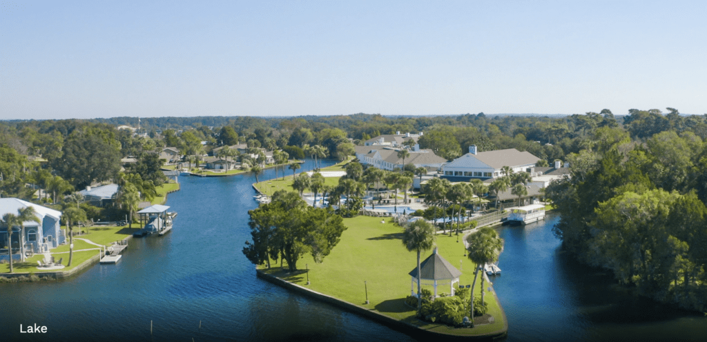 a body of water with houses and trees