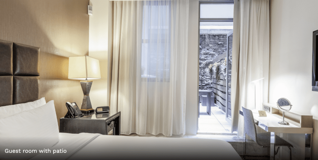 a bedroom with a lamp and a table
