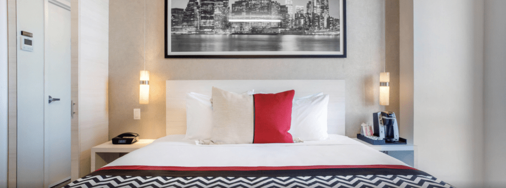 a bed with a picture on the wall