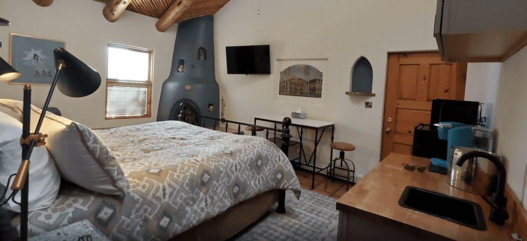 a room with a bed and a television