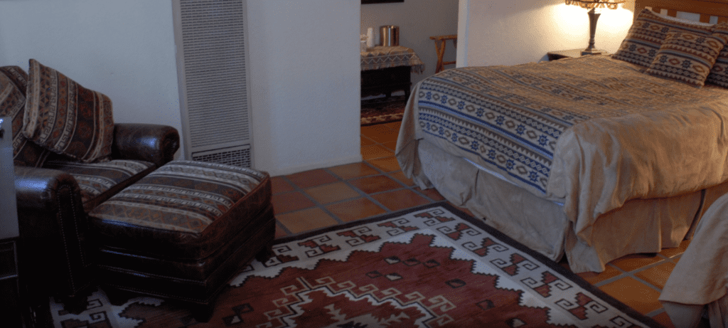 a room with two beds and a rug