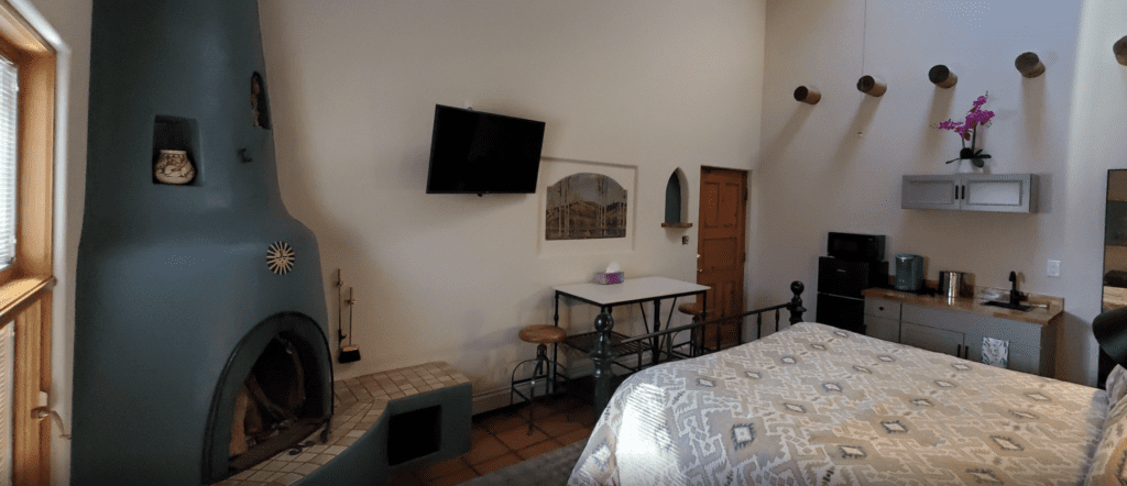 a room with a bed and a tv on the wall