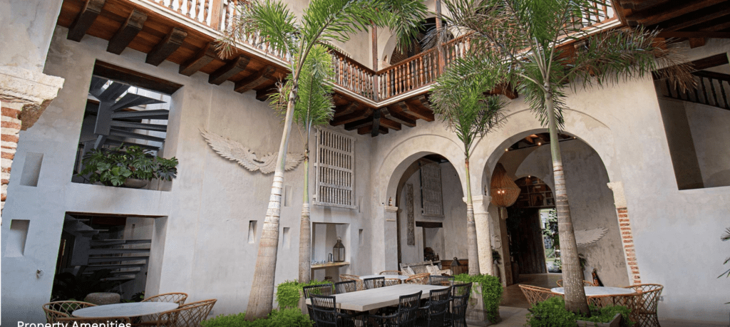 a patio with tables and chairs in a courtyard