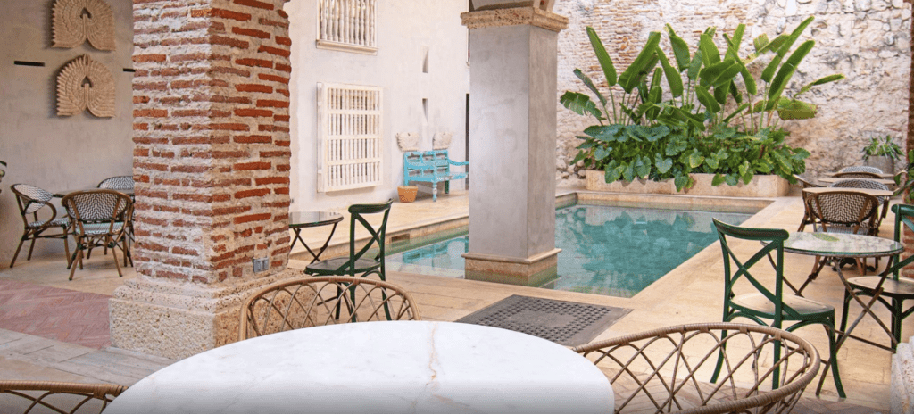 a pool with chairs and tables