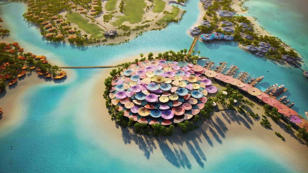 an aerial view of an island with umbrellas