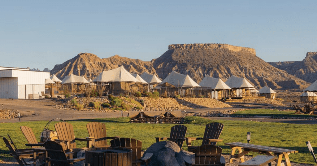 a group of chairs and tents in a field