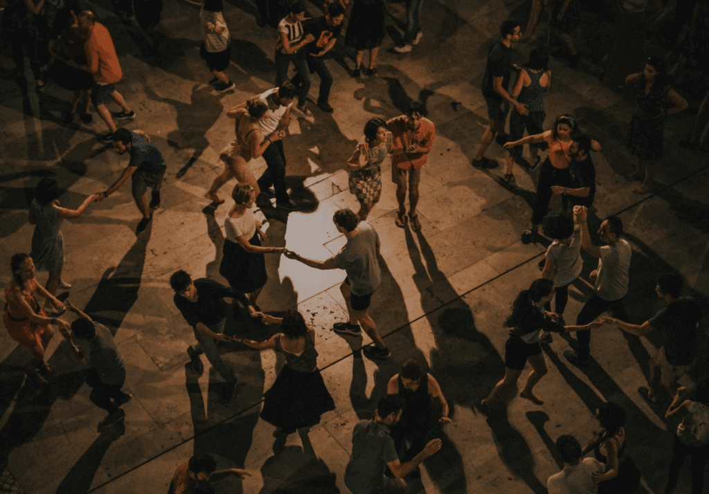 a group of people dancing in a circle